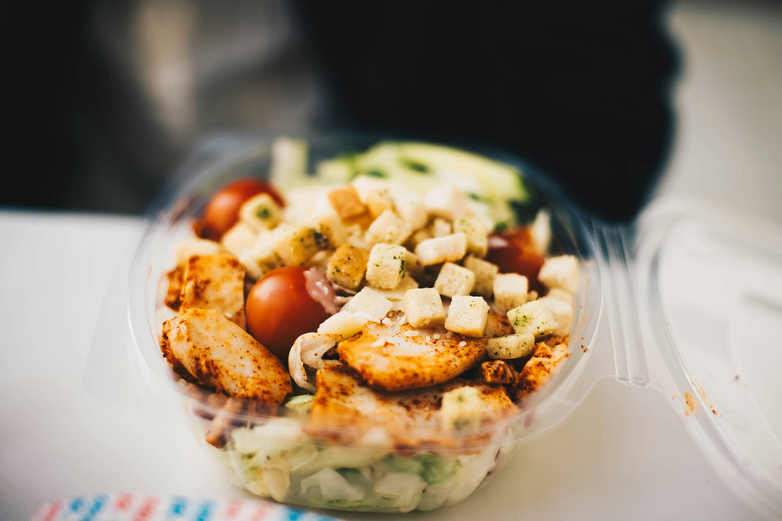 Delicious chicken salad with fresh greens and croutons, perfect for a healthy meal.