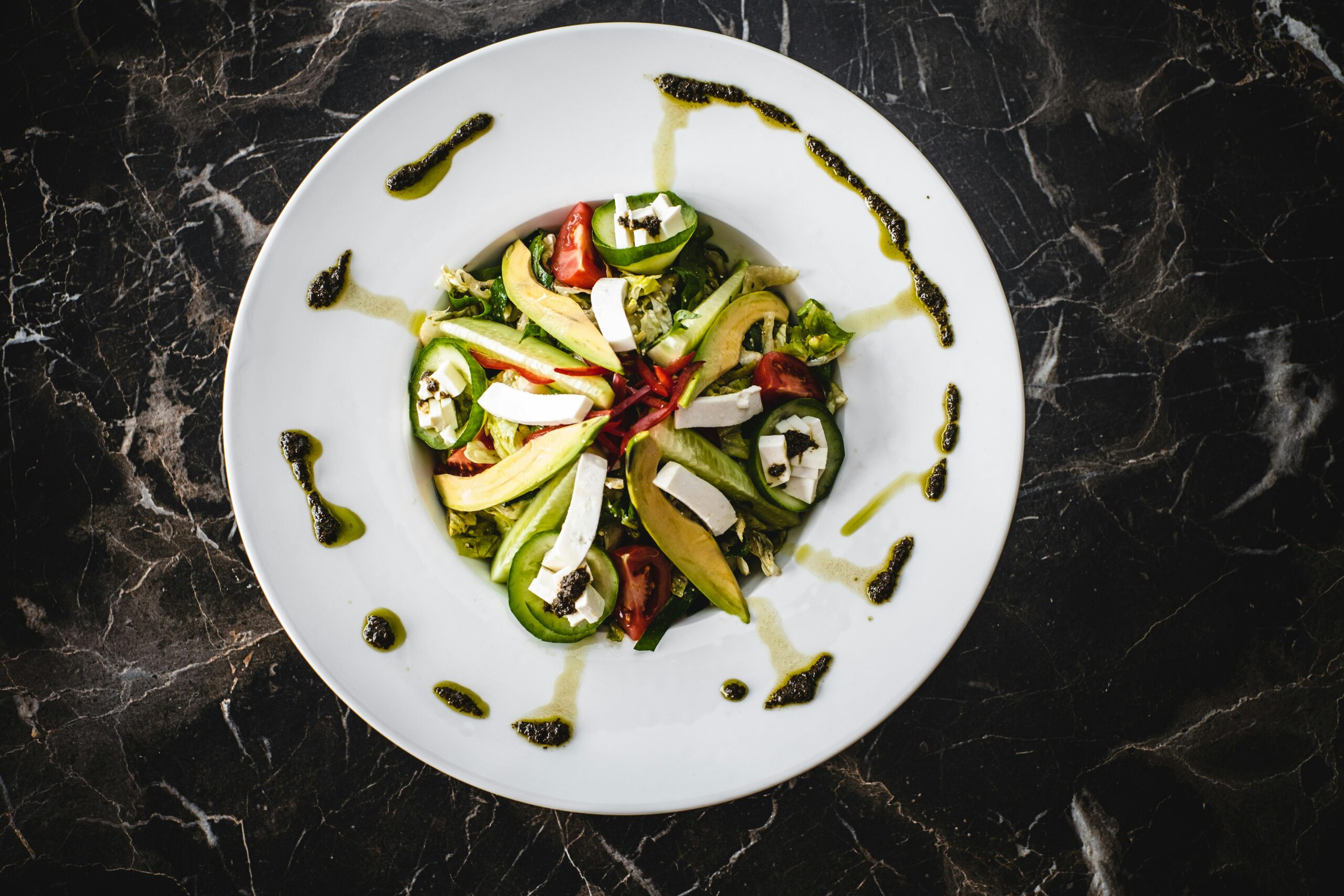 Healthy avocado salad with feta, showing plant-based meal options.