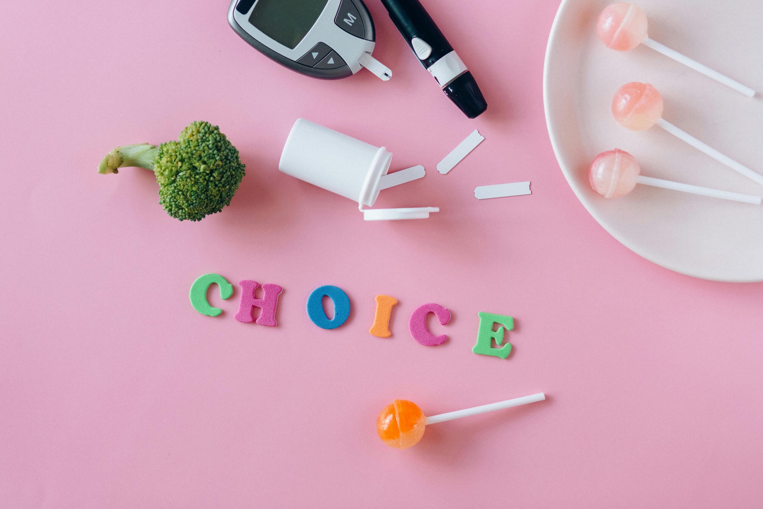 Conceptual image highlighting choice between health foods and sweets, symbolized by broccoli and lollipops.