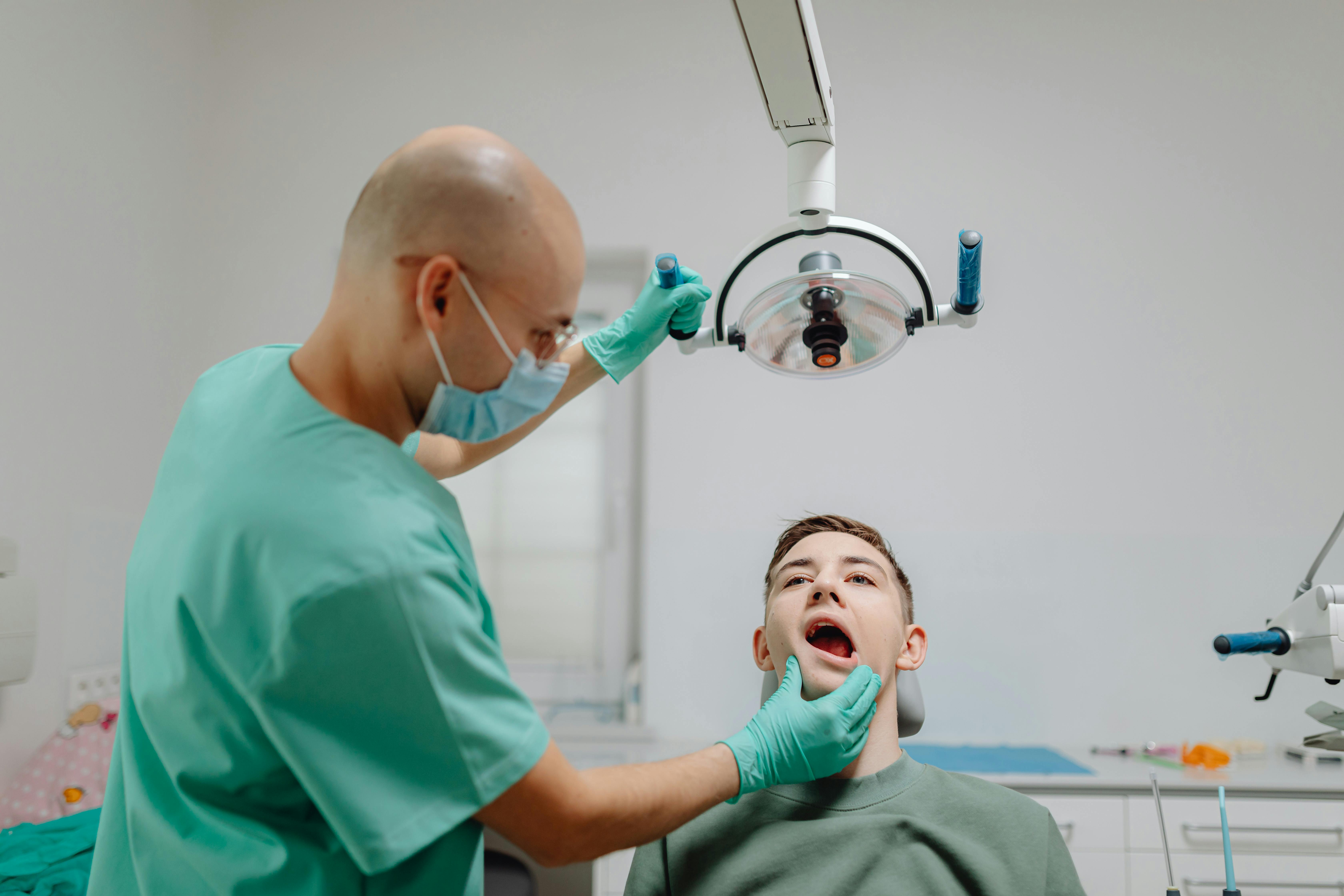 A dentist performs a routine checkup on a patient in a modern dental clinic setting.