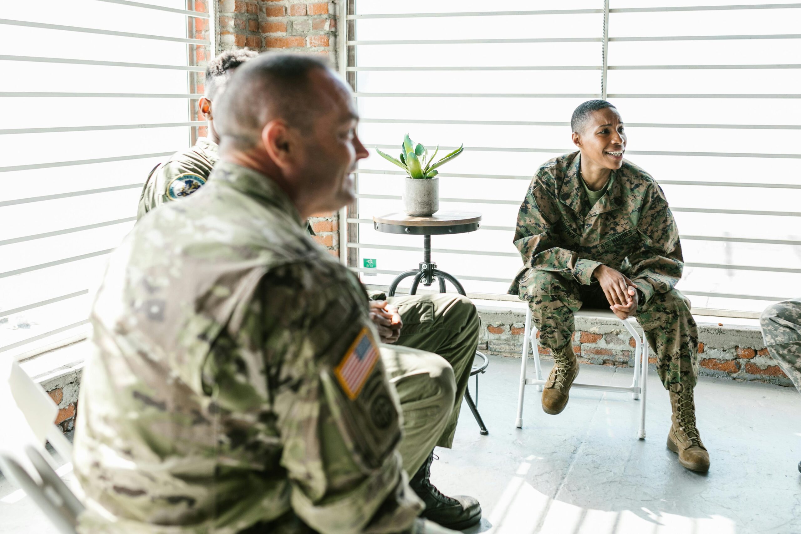 A group of military veterans in a supportive therapy session, fostering healing and togetherness.