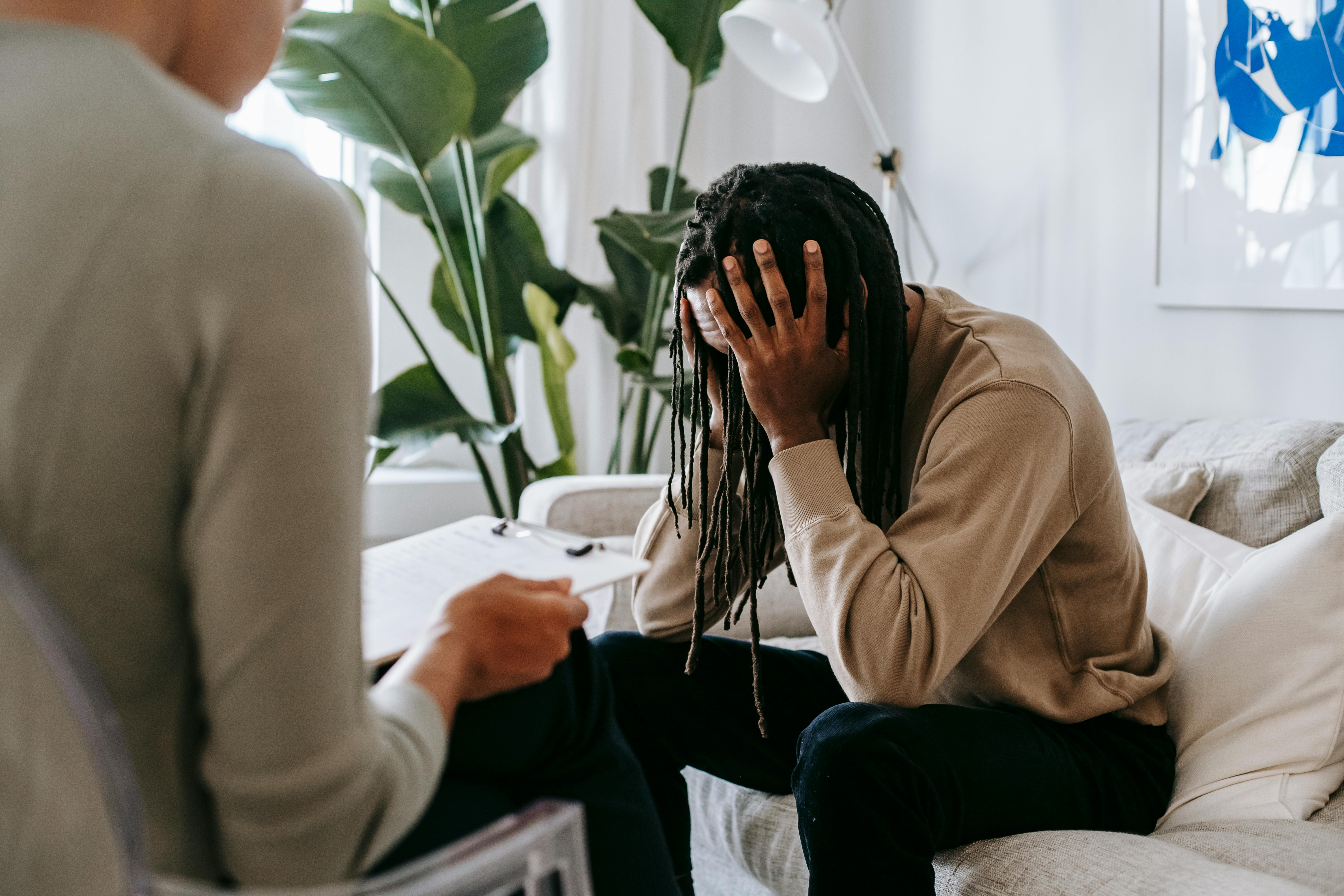 A concerned client in therapy, seeking professional support and guidance indoors.